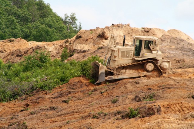 Sgt. Jacob Hanson with the Wisconsin National Guard's 950th Engineering Company (Route Clearance) operates a bulldozer at a training area July 12, 2021, at Fort McCoy, Wis. The work is part of a troop project coordinated by the Fort McCoy...