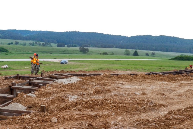 2nd Lt. Andrew Pitsenberger, third platoon leader, Argonaut Troop, Regimental Engineer Squadron, 2nd Cavalry Regiment, and Capt. Chris Bartenhagen, the Argonaut Troop commander, look over the construction of a 100-meter trench June 4, 2021 on...