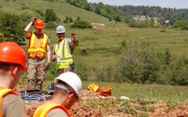 Chief Warrant Officer 2 Raymond Cowden, a construction engineering technician with the Joint Multinational Readiness Center's Troop Construction Program, right, and 2nd Lt. Andrew Pitsenberger, third platoon leader, Argonaut Troop, Regimental...