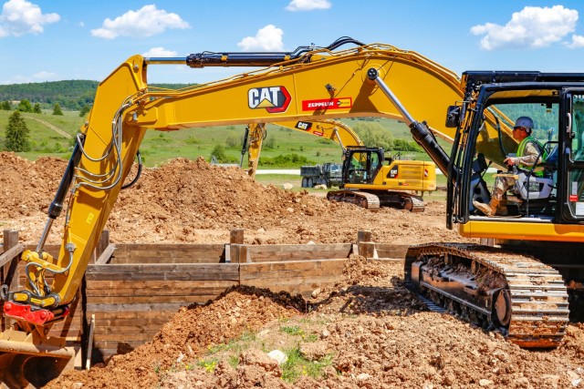 Chief Warrant Officer 2 Raymond Cowden, a construction engineering technician with the Joint Multinational Readiness Center’s Troop Construction Program, backfills some dirt along a 100-meter trench at the Hohenfels Training Area, Hohenfels,...