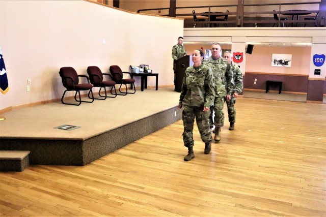 Command Sgt. Maj. Raquel DiDomenico, new Fort McCoy Garrison command sergeant major (CSM); Garrison Commander Col. Michael Poss; and Command Sgt. Maj. Paul Mantha, former garrison CSM, walk in formation back to their seats July 1, 2021, during a...