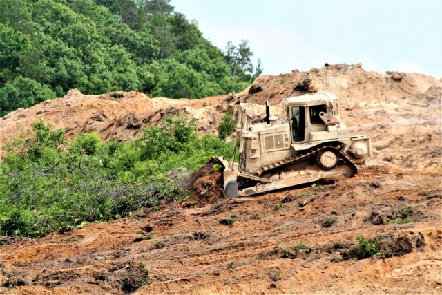 Sgt. Jacob Hanson with the Wisconsin National Guard's 950th Engineering Company (Route Clearance) operates a bulldozer at a training area July 12, 2021, at Fort McCoy, Wis. The work is part of a troop project coordinated by the Fort McCoy...