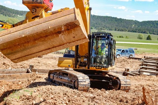 Chief Warrant Officer 2 Raymond Cowden, a construction engineering technician with the Joint Multinational Readiness Center’s Troop Construction Program, backfills some dirt along a 100-meter trench at the Hohenfels Training Area, Hohenfels,...