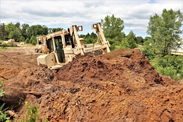 Spc. Seth Abbot with the Wisconsin National Guard's 950th Engineering Company (Route Clearance) operates a bulldozer at a training area July 12, 2021, at Fort McCoy, Wis. The work is part of a troop project coordinated by the Fort McCoy...