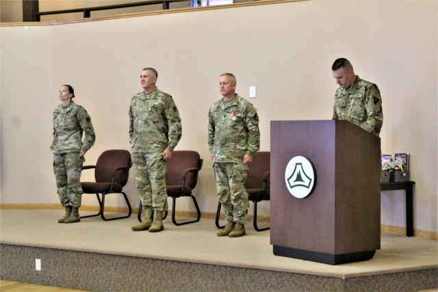 Garrison leaders stand at attention after Command Sgt. Maj. Paul Mantha, former Fort McCoy Garrison command sergeant major, received the Legion of Merit in a special awards presentation ceremony July 1, 2021, at Fort McCoy, Wis. Garrison Commander...
