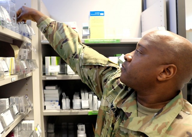 U.S. Army Sgt. Walter Howard II, noncommissioned officer in charge, Pharmacy Department, U.S. Army Health Clinic Baumholder, restocks medications during normal operations at the USAHC Baumholder Pharmacy, May 26.