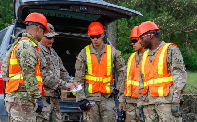 Chief Warrant Officer 2 Raymond Cowden, a construction engineering technician with the Joint Multinational Readiness Center’s Troop Construction Program, talks with engineer Soldiers from third platoon, Argonaut Company, Regimental Engineer...