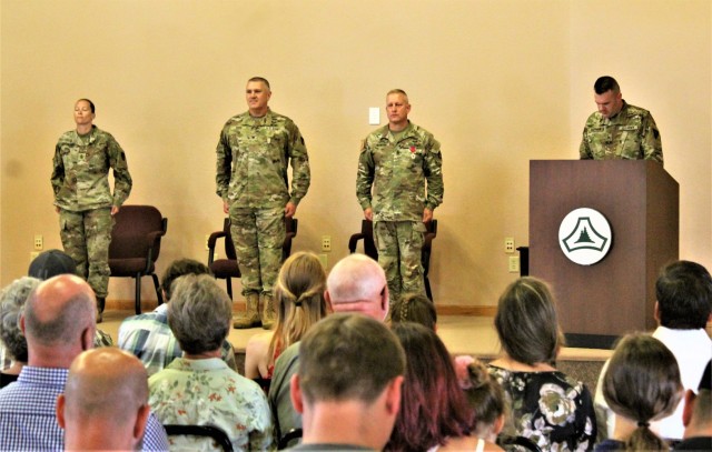 Garrison leaders stand at attention after Command Sgt. Maj. Paul Mantha, former Fort McCoy Garrison command sergeant major, received the Legion of Merit in a special awards presentation ceremony July 1, 2021, at Fort McCoy, Wis. Garrison Commander...