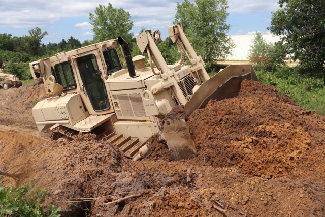 Spc. Seth Abbot with the Wisconsin National Guard's 950th Engineering Company (Route Clearance) operates a bulldozer at a training area July 12, 2021, at Fort McCoy, Wis. The work is part of a troop project coordinated by the Fort McCoy...