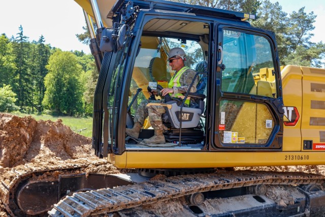 Chief Warrant Officer 2 Raymond Cowden, a construction engineering technician with the Joint Multinational Readiness Center’s Troop Construction Program, backfills some dirt along a 100-meter trench at the Hohenfels Training Area, Hohenfels,...