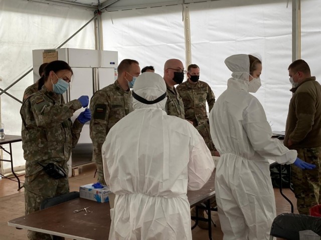 U.S. Army photo by Spc. Caleb Scibbe. Spc. Caleb Summers and Lithuanian Defense Forces personnel package COVID test samples at Siauliai AB, Lithuania during Swift Response 21, a U.S. Army Europe and Africa-directed exercise led by the U.S....