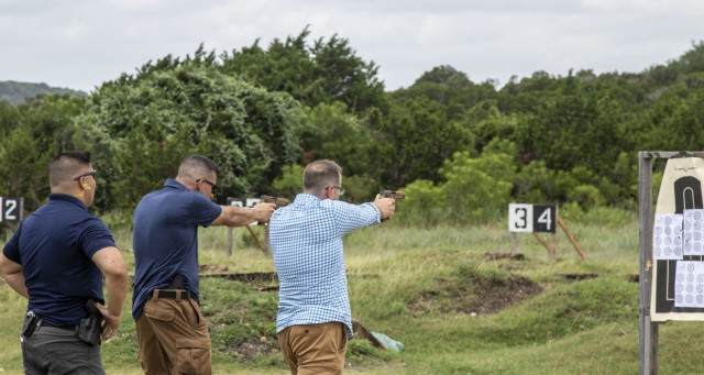 Special Agent David Lim, 43rd Military Police Detachment (Criminal Investigative Division), observes as a Soldiers from the 403rd Civil Affairs Battalion, fire a SIG Sauer M17 service pistol, while conducting concealed carry training, July 10,...