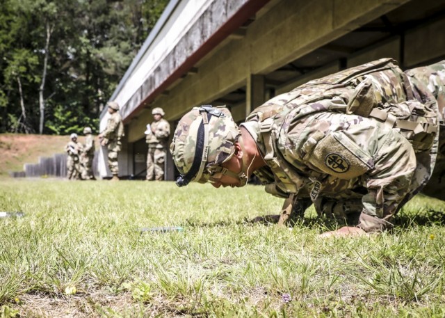 LANDSTUHL, Germany – U.S. Army Spc. Phillip Xu, pharmacy technician, Landstuhl Regional Medical Center, performs a burpee with full combat gear during the stress shoot portion of Landstuhl Regional Medical Center’s Best Warrior Competition, July 7. The competition challenged Soldiers from across Germany, Belgium and Italy, physically, emotionally and spiritually as they were tested on various tasks and skills including Army Warrior Tasks, medical knowledge and prolonged field care, stress shoot, military Drill and ceremony, ruck marches, Land navigation, combat lifesaving under pressure, combat water survival, and written and oral examinations.