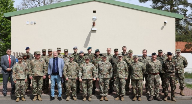 Personnel from the United Kingdom, Germany, France, the Netherlands, Hungary, Poland, Austria, Czech Republic, and Ukraine stand with their U.S. Army Allies in front of the Readiness and Movement Coordination Center, Panzer Kaserne, Germany,...