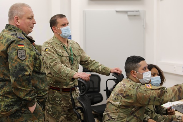 (l to r) German Army Capt. Andreas Kirk, UK WO1 Craig Lovitt, U.S. Army Staff Sgt. John Carmona and U.S. Army Spc. Shakwanna Jeffers monitor Logistic Functional Area Services activity at the Readiness and Movement Coordination Center, Panzer...