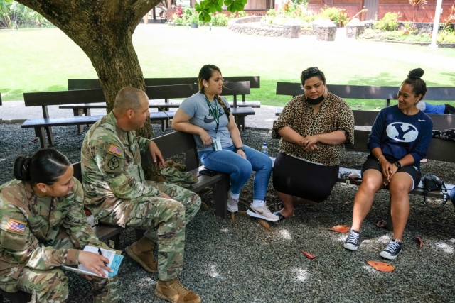 From left, U.S. Army Sgt. Alavoni Tukunga and Army Capt. Daniel Thomassian of the 9th Mission Support Command’s Task Force Oceania meet with students from Brigham Young University-Hawaii at the Polynesian Cultural Center on June 6. The meeting gave the Soldiers insight into the daily lives of the students and the Kingdom of Tonga. (U.S. Army photo by Sgt. Teresa Cantero)