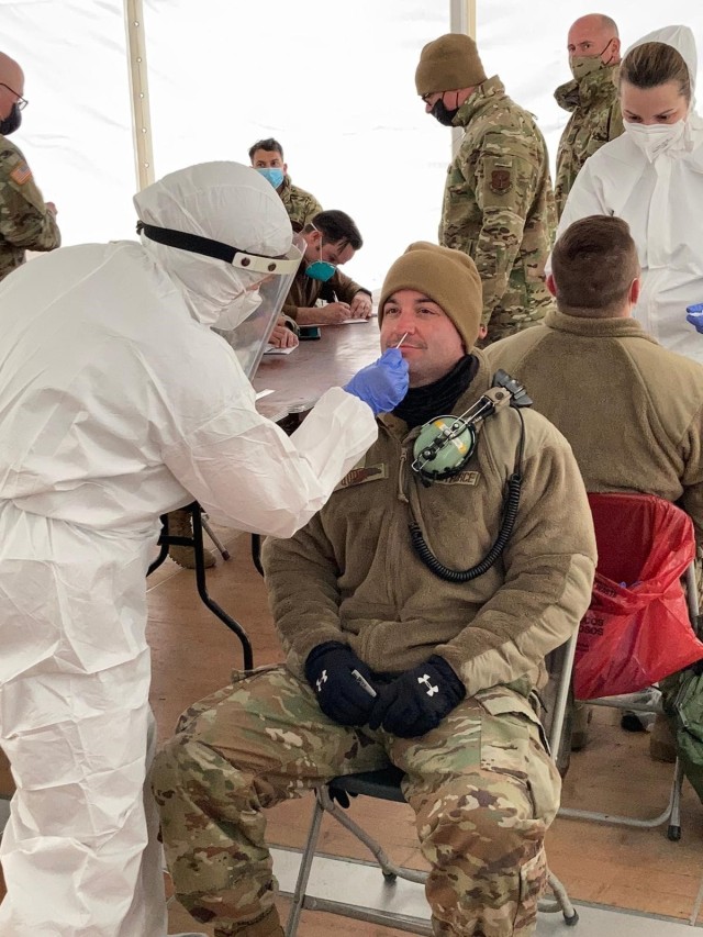 U.S. Army photo by Spc. Caleb Scibbe. Lithuanian Defense Forces medic administers polymerase chain reaction COVID test to U.S. Air Force personnel at Siauliai AB, Lithuania during Swift Response 21. The DEFENDER-Europe 21-linked exercise is...