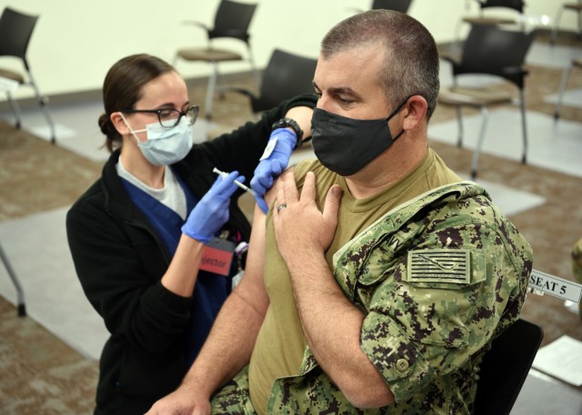 JOINT BASE SAN ANTONIO-LACKLAND AFB – (Feb. 1, 2021) Chief Quartermaster Harry Warner, of Alvin, Texas, an enlisted classifier/shipping clerk assigned to Navy Talent Acquisition Group (NTAG) San Antonio, receives the initial dose of the COVID-19...