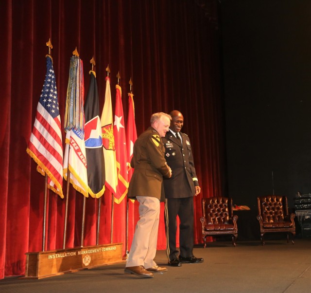 Lt. Gen. Doug Gabram (left) congratulates Brig. Gen. Omuso D. George at a retirement ceremony July 16 in the Fort Sam Houston Theater. 