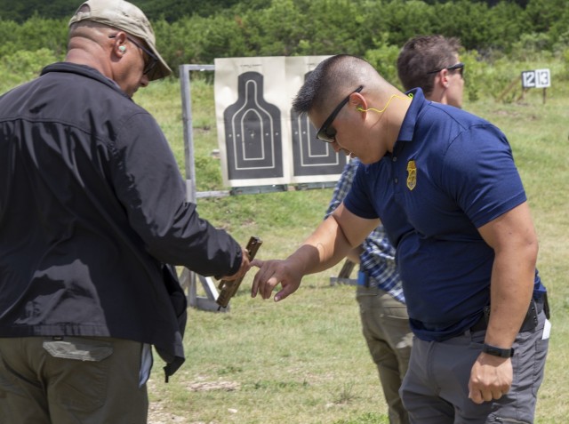 Special Agent David Lim, 43rd Military Police Detachment (Criminal Investigative Division), checks a SIG Sauer M17 service pistol while conducting concealed carry training, during a collaborative training effort with the 1-393rd Brigade Support Battalion, and 2-337th REGT, Training Support Battalion (CS/CSS) (Wolverines), both part of the 120th Infantry Brigade, July 10, 2021, at Fort Hood, Texas. The training effort was conducted for the or the 403rd Civil Affairs Battalion, in preparation for an overseas mission and to train Soldiers from the 120th on how to conduct the class for future deploying units. (U.S. Army Reserve Photo Staff Sgt. Erick Yates)