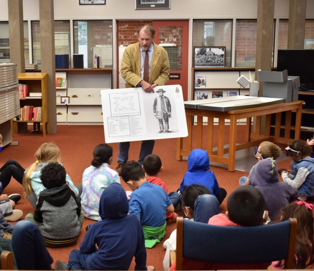 Cameron Binkley, command historian, Defense Language Institute Foreign Language Center, speaks to children from the Porter Youth Center about history at the Brig. Gen. Harry Dwight Chamberlin Library, Ord Military Community, Calif., July 15.