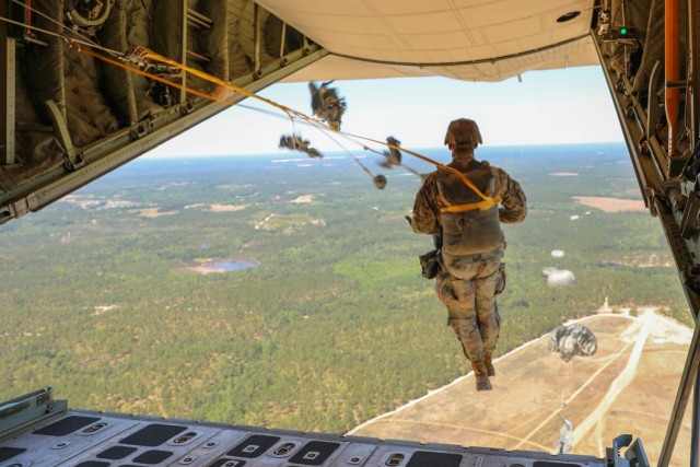 Stepping out into open air, Headquarters and Headquarters Company, U.S. Army Civil Affairs and Psychological Operations Command (Airborne) Soldiers exit a U.S. Marine KC-130 aircraft during a static line jump over Sicily Drop Zone, Ft. Bragg, N.C., May 1, 2021. The tail ramp jump allowed Soldiers the opportunity to refresh their skills and update their jump qualifications.