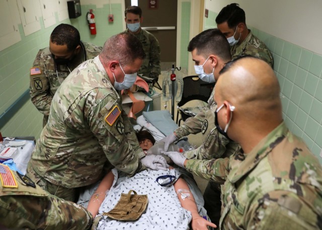 Soldiers from Regional Health Command-Atlantic and the U.S. Army Medical Research and Development Command stabilize a notional patient during the assessment for the Delayed Evacuation Casualty Management (DECM) training held at Kimbrough Ambulatory Care Center July 16, 2021. The five Soldiers completed the five-day course and learned critical care concepts preparing them to stabilize and sustain a casualty in an extended-care scenario before casualty evacuation. (U.S. Army photo by Michelle Gonzalez)