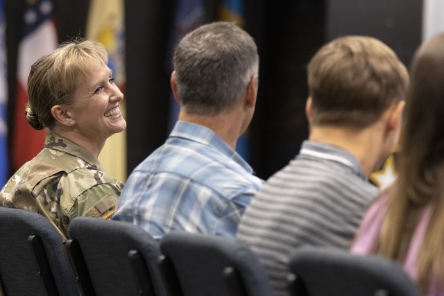 Col. Paige M. Jennings, U.S. Army Financial Management Command commander, is all smiles as she looks at her husband, Larry Jennings, during a ceremony at the Maj. Gen. Emmett J. Bean Federal Center in Indianapolis July 15, 2021. During his remarks, Gen. Edward M. Daly, U.S. Army Materiel Command commanding general, noted that the Jennings 28th wedding anniversary was two days after the assumption of command ceremony. (U.S. Army photo by Mark R. W. Orders-Woempner)