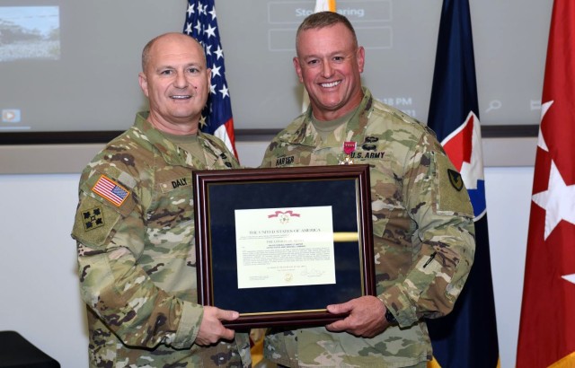 Army Materiel Command’s Maj. Gen. Bob Harter, right, receives the Legion of Merit, presented by AMC Commander Gen. Ed Daly during a July 20 farewell and awards ceremony at AMC Headquarters, Redstone Arsenal, Ala. The award recognizes Harter’s ability as a multi-functional logistician. Harter is going to be the as Deputy Chief of Army Reserve, Office of the Chief of Army Reserve. (U.S. Army Photo by Doug Brewster)