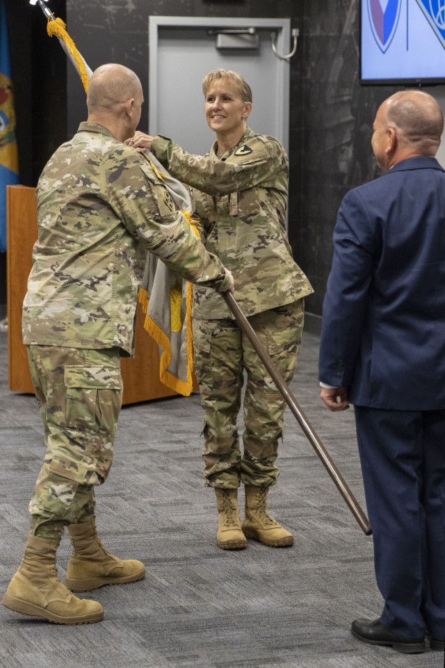 Gen. Edward M. Daly, U.S. Army Materiel Command commanding general, passes the U.S. Army Financial Management Command colors to Col. Paige M. Jennings as she assumes command of USAFMCOM during a ceremony at the Maj. Gen. Emmett J. Bean Federal Center in Indianapolis July 15, 2021. Also pictured is Barry Hoffman, USAFMCOM deputy to the commander, who temporarily led the command as its executive director until Jennings could assume command. (U.S. Army photo by Mark R. W. Orders-Woempner)