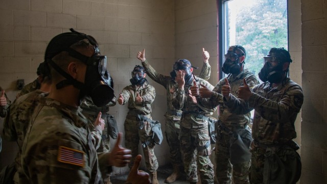 Cadre and Cadets of 7th Regiment, Advanced Camp give thumbs up while checking the capabilities of their M50 Protective Masks in the confidence chamber at Fort Knox, KY during Chemical, Biological, Radiological, and Nuclear training on July 7,...