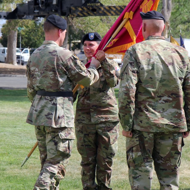 Lt. Col. Amy Cory (center), incoming Sierra Army Depot commander, recieves the U.S. Army Tank-automotive and Armarments Command (TACOM) guideon from Maj. Gen. Darren L. Werner, U.S. Army TACOM commanding general, during the depot&#39;s change of...