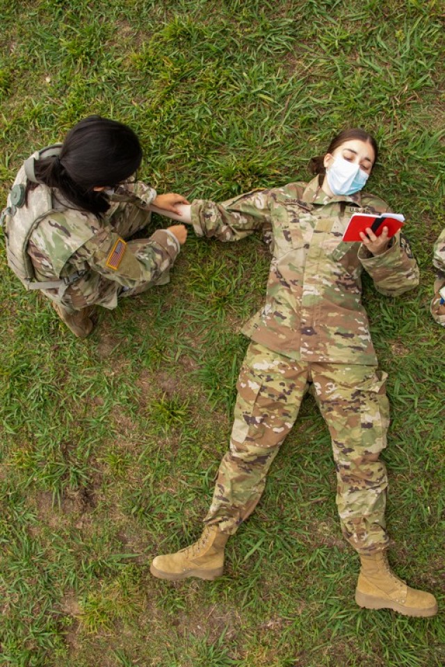 Cadet Gabrielle Soares, Drexel University, plays the role of the injured soldier to give Cadet Barbara Luciano, University of Puerto Rico, real time feedback during the First Aid portion of Warrior Skills at Fort Knox, Ky., on June 21, 2021. The Warrior Skills training event consists of two parts, Call for Fire and First Aid, that will be important for any Cadet to have knowledge when leading their future soldiers. | Photo by Jacob Hempen, CST Public Affairs Office