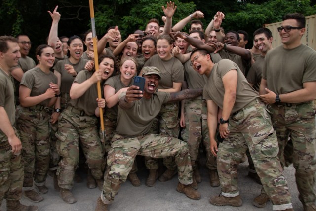 1st Regiment, Alpha Company Cadets pose for a selfie and celebrate after completing the 12 Mile Foot March, the last training event of Advanced Camp in Fort Knox, Ky. June 25, 2021 | Photo by Rachael Kocour, CST Public Affairs Office.