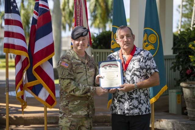 Maj. Gen. Chris Mohan, commanding general for the Army Sustainment Command, poses with Joe Schulz, deputy to the commander for the 402nd Army Field Support Brigade, after presenting him with the Ordinance Order of Samuel Sharpe.