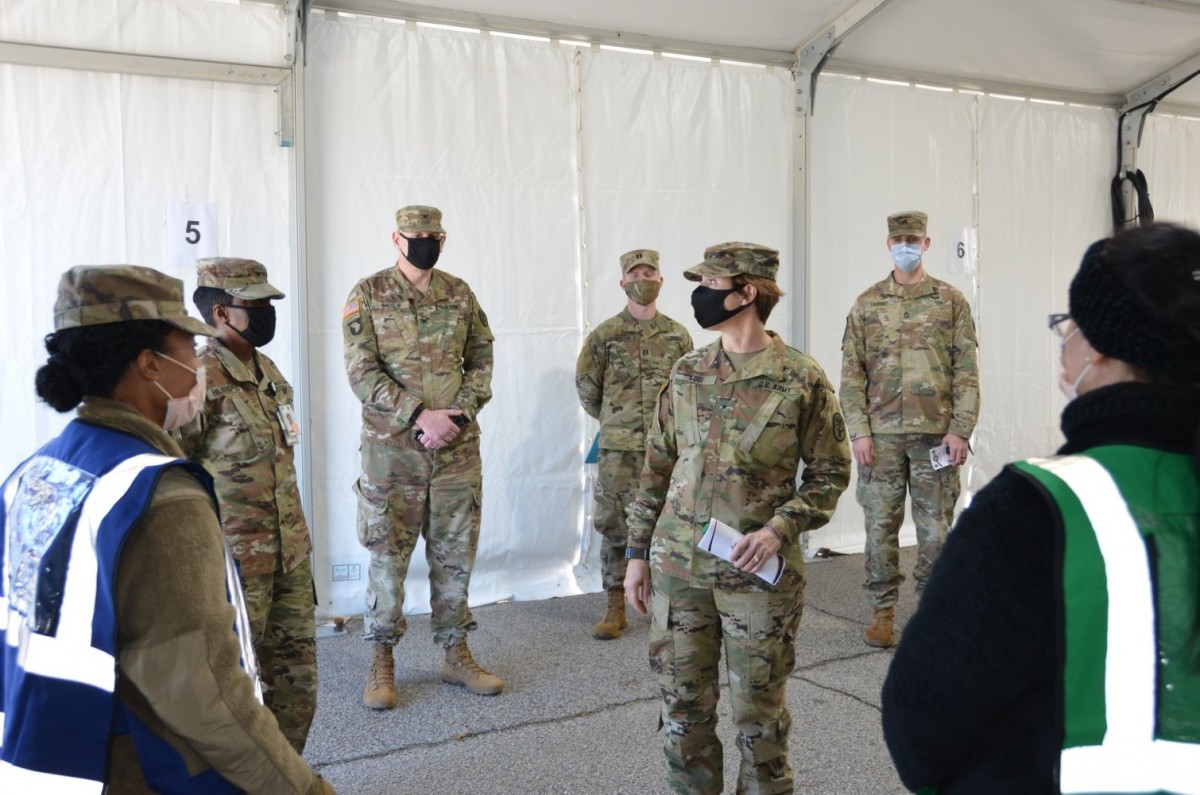 Brig. Gen. Paula Lodi, center, then-commander of Regional Health Command-Atlantic, visits with Soldiers at the Eisenhower Army Medical Center at Fort Gordon, Ga., in January 2021. Soldiers at Fort Gordon shifted some operations outdoors to follow COVID-19 safety protocols during pandemic restrictions. (Courtesy photo)