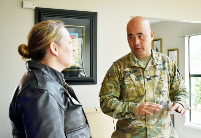 Col. Varman Chhoeung, commander of U.S. Army Garrison Presidio of Monterey, speaks with Air Force Lt. Col. Jen Whetstone, who is moving to Japan with her family, as movers pack up her household goods in Pebble Beach, Calif., July 16. Chhoeung accompanied a quality assurance inspector with the Presidio of Monterey Transportation Office to speak with service members and their families and ensure their permanent-change-of-station moves are going well.