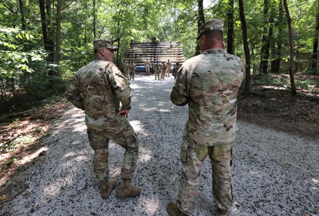 Walker and Clemmer discuss 2021 Cadet Summer Training progress as cadets practice weaving over and under an obstacle at Fort Knox on July 23, 2021.