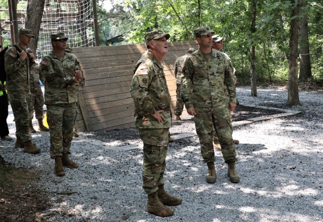 Lt. Gen. Donnie Walker, alongside  Creighton University professor of military science Lt. Col. Mark Hayes, observes cadets negotiating a series of obstacles during training at Fort Knox on July 23, 2021. 