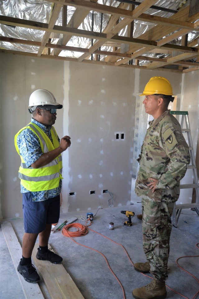 Kwajalein Atoll Development Authority Executive Director Anjo Kabua speaks with U.S. Army Garrison-Kwajalein Atoll Commander Col. Thomas Pugsley Pugsley inside a home under construction for the mid-atoll corridor housing project during Pugsley's first visit to Ebeye July 16, 2021. (U.S. Army photo by Mike Brantley)