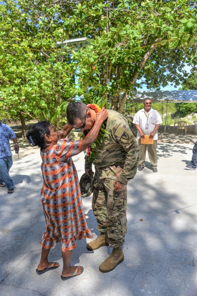 U.S. Army Garrison-Kwajalein Atoll Commander Col. Thomas Pugsley receives a wut marmar at the home of Iroijlaplap Sen. Michael Kabua during his first visit to Ebeye July 16, 2021. (U.S. Army photo by Mike Brantley)