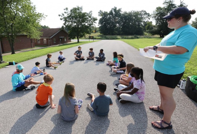 Sitting in the sunshine: Kids learn about the day’s Bible verse through a version of the game Hot Potato.