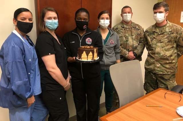 Capt. Carolyn Baremore, Clinical Nurse Officer in Charge of the Emergency Department, pictured 3rd from right celebrating a colleague's birthday.