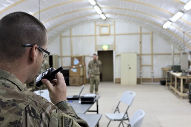 Spc. Curtis Hicks, left, from the Tennessee National Guard, 1-181st Field Artillery Battalion, conducts Counter Radio-Controlled Improvised Explosive Device Warfare (CREW) system training with Task Force Phoenix Electronic Warfare Technician Chief Warrant Officer 2 Anthony Meneely, at Camp Buehring, Kuwait.