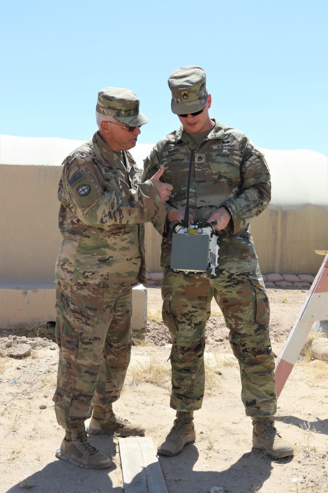 Illinois National Guard Soldier Chief Warrant Officer 2 Anthony Meneely instructs Staff Sgt. Thomas Daniel, Tennessee National Guard, the 1-181st Field Artillery Battalion, on the operation of a Counter Radio-Controlled Improvised Explosive Device Warfare (CREW) system at Camp Buehring, Kuwait.