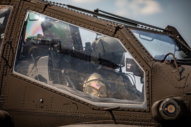 U.S. Army Spc. Hank Livingston, a crew chief with Charlie Company “Ghost Riders,” 1st Battalion, 1st Aviation Regiment, 1st Combat Aviation Brigade, prepares for a ride on an AH-64 Apache at Illesheim Army Airfield, Germany, July 22, 2021. Livingston was given a morale flight in recognition of his outstanding service to the battalion. 