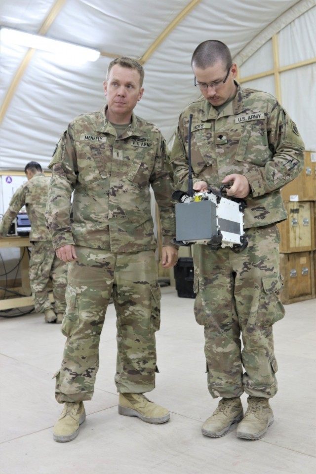 Chief Warrant Officer 2 Anthony Meneely, left, an Electronic Warfare Technician with Task Force Phoenix, instructs Spc. Curtis Hicks, from the Tennessee National Guard, 1-181st Field Artillery Battalion, on the operation of a Counter Radio-Controlled Improvised Explosive Device Warfare (CREW) system at Camp Buehring, Kuwait.