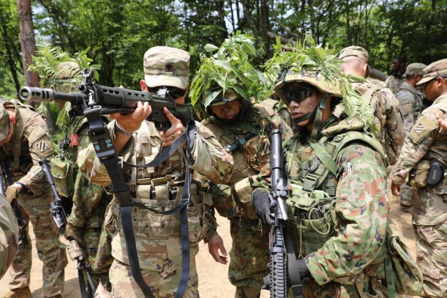 U.S. Army Spc. Vuongkhang Luong, an Adairsville, Georgia, native and infantryman with 1st Battalion, 28th Infantry Regiment "Black Lions," 3rd Infantry Division, looks down the sights of a Japan Ground Self-Defense Force weapon during exercise Orient Shield 21-2 at Aibano Training Area, Japan, June 24, 2021. Luong and other Black Lions trained alongside JGSDF members throughout the duration of the exercise.