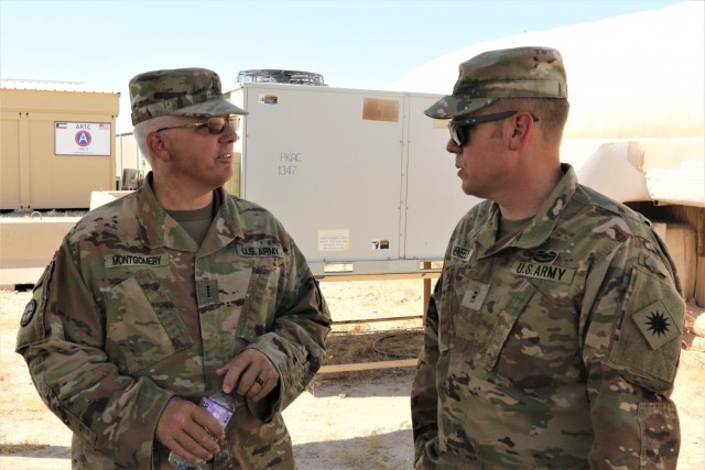 Florida National Guard Soldier Chief Warrant Officer 4 Douglas Montgomery and Illinois National Guard Soldier Chief Warrant Officer 2 Anthony Meneely discuss Counter Radio-Controlled Improvised Explosive Device Warfare (CREW) system training at Camp Buehring, Kuwait. Montgomery and Meneely are Electronic Warfare Technicians in the Task Force Phoenix Cyberspace Electromagnetic Activities (CEMA) cell.