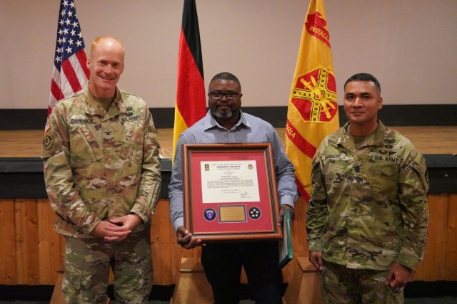 From left to right stand USAG Bavaria Commander Col. Christopher Danbeck, garrison human resources assistant Marlon S. Laidley and Command Sgt. Maj. Sebastian Camacho, July 15, 2021. Laidley was awarded the Frederick E. Vollrath award at an All Hands workforce meeting. (U.S. Army photo by Andreas Kreuzer)